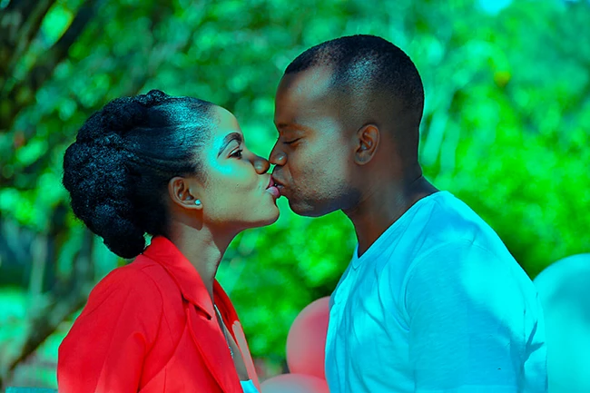 Woman holding her friend’s arm while posing together during outdoor photoshoot